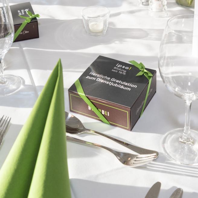 Kleine Geschenkschachtel auf bedecktem Tisch